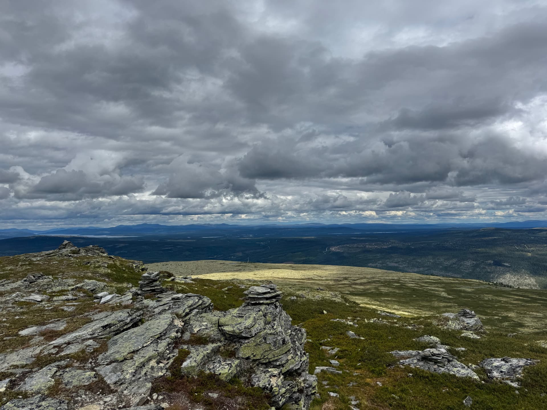 Rocky ridge on the summit of Mount Kvitvola looking out over forested valleys in Engerdal